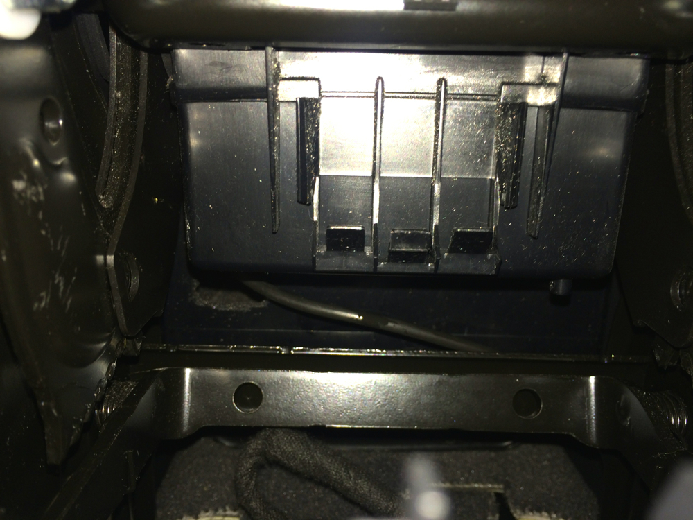 Route the cable through the back of the center console
