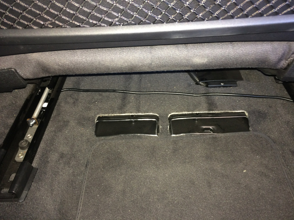 Routing cable under passenger seat